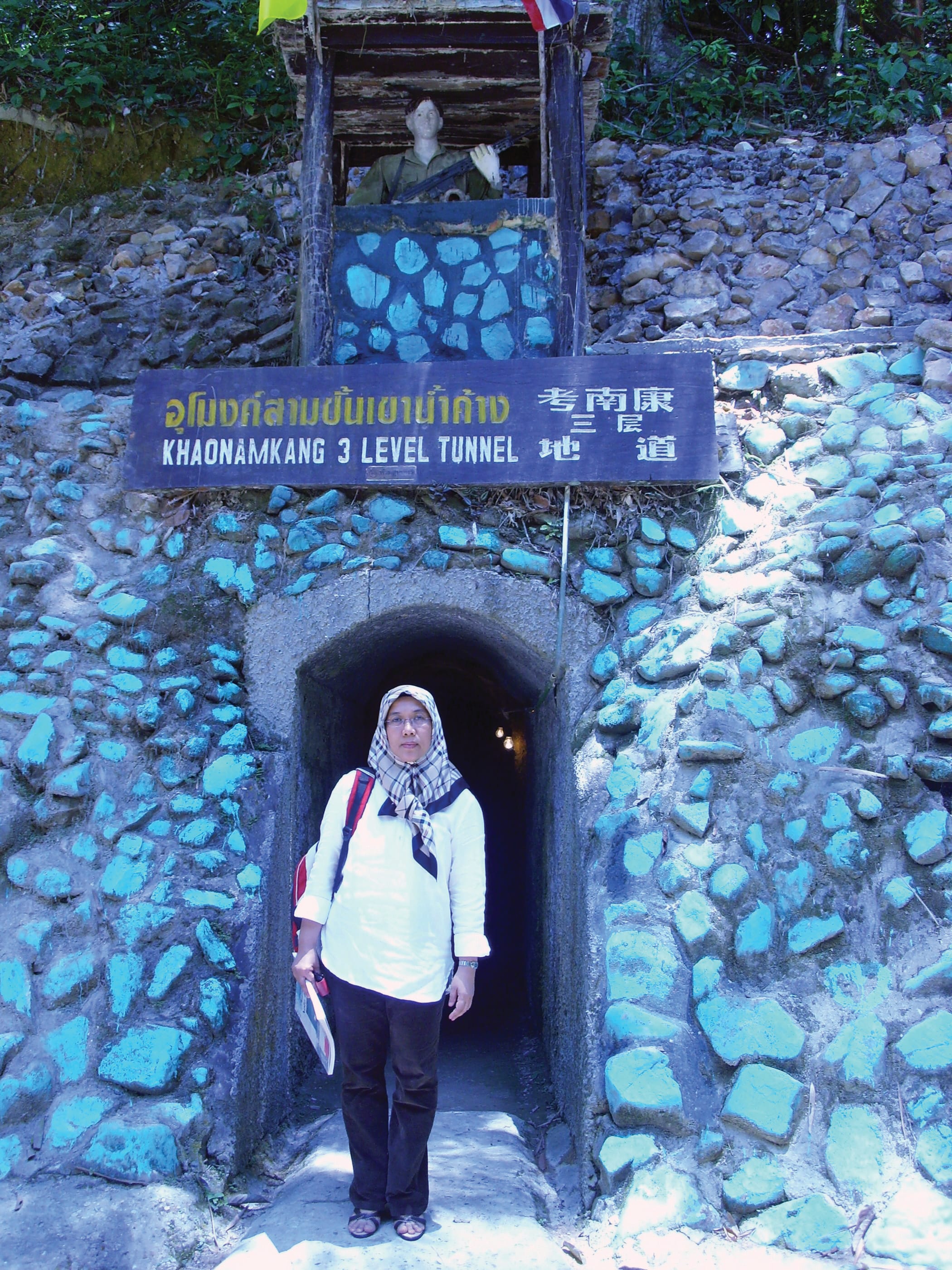 The author at the entrance of the Khao Nam Khang Historical Tunnel Natawee District, Songkhla Province, which used to be the base camp for the 8th Regiment. Photo courtesy of Mahani Awang.
